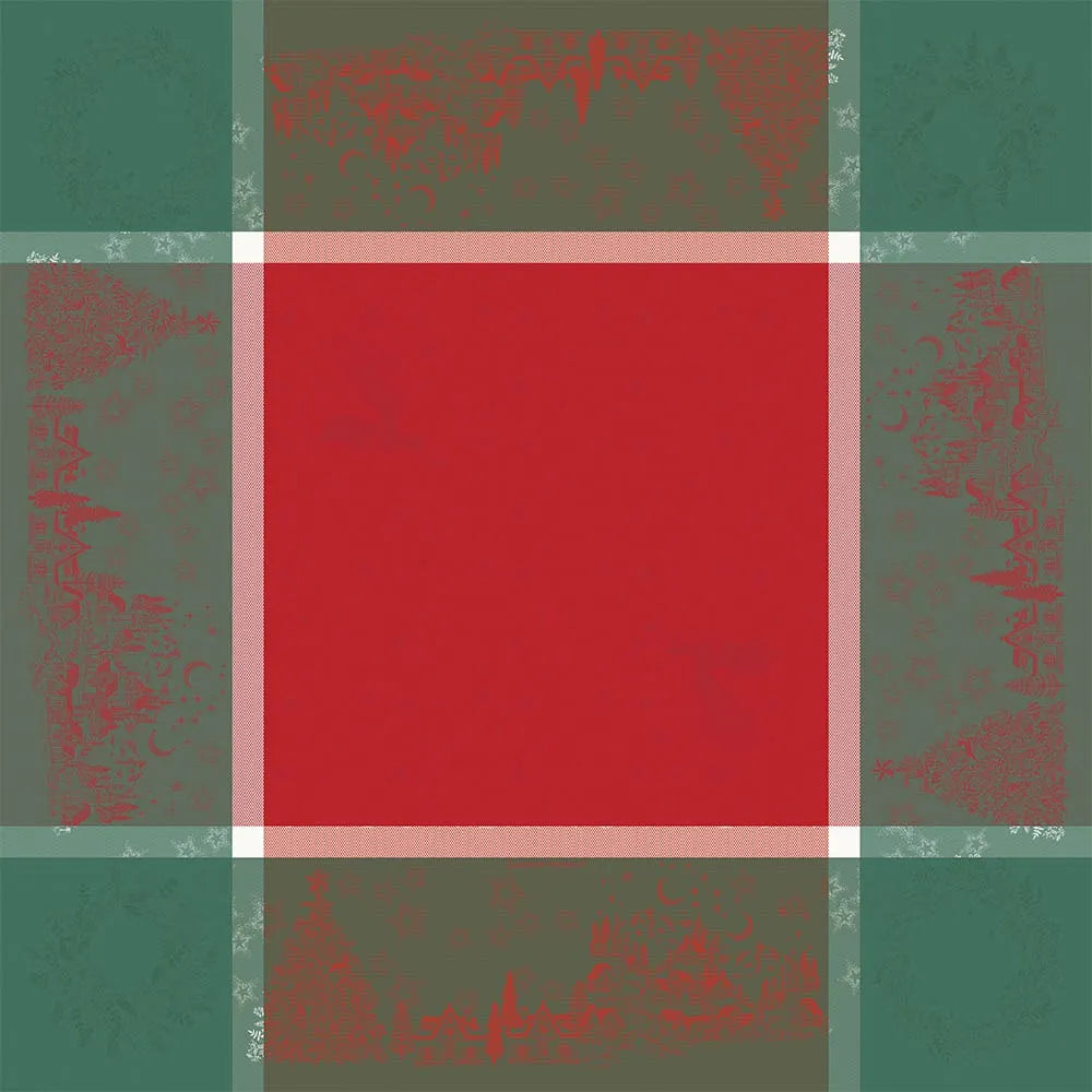 A flat lay view of the Noel Magique Houx cotton jacquard tablecloth spread flat. It features a vibrant, solid red square center framed by white-and-red textured striped borders, with a wide, forest green outer border woven with delicate red holiday illustrations including Christmas trees, houses, and stars.