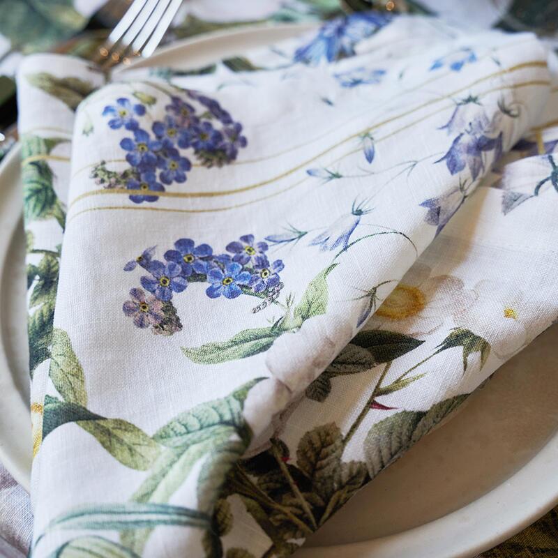 Close up of the Blue Flower Garden patterned napkin folded on a plate