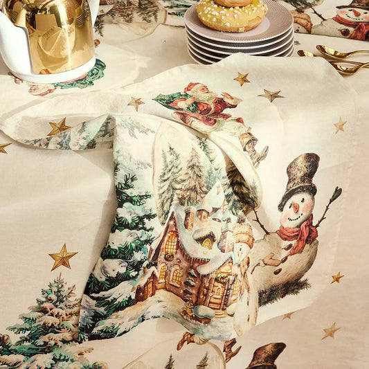 Decorative tablecloth and napkin with a vintage Christmas design featuring a snowman and winter scene.