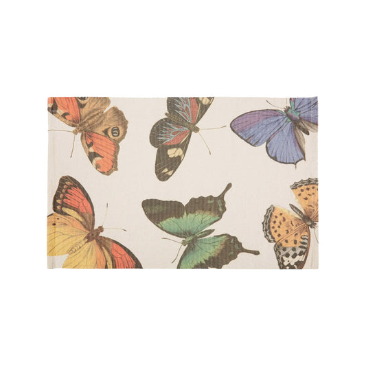 A top-down view of a rectangular cream cotton bath rug featuring a large-scale, detailed vintage botanical illustration of five distinct butterflies with patterned wings in shades of orange, purple, sage green, and golden yellow.