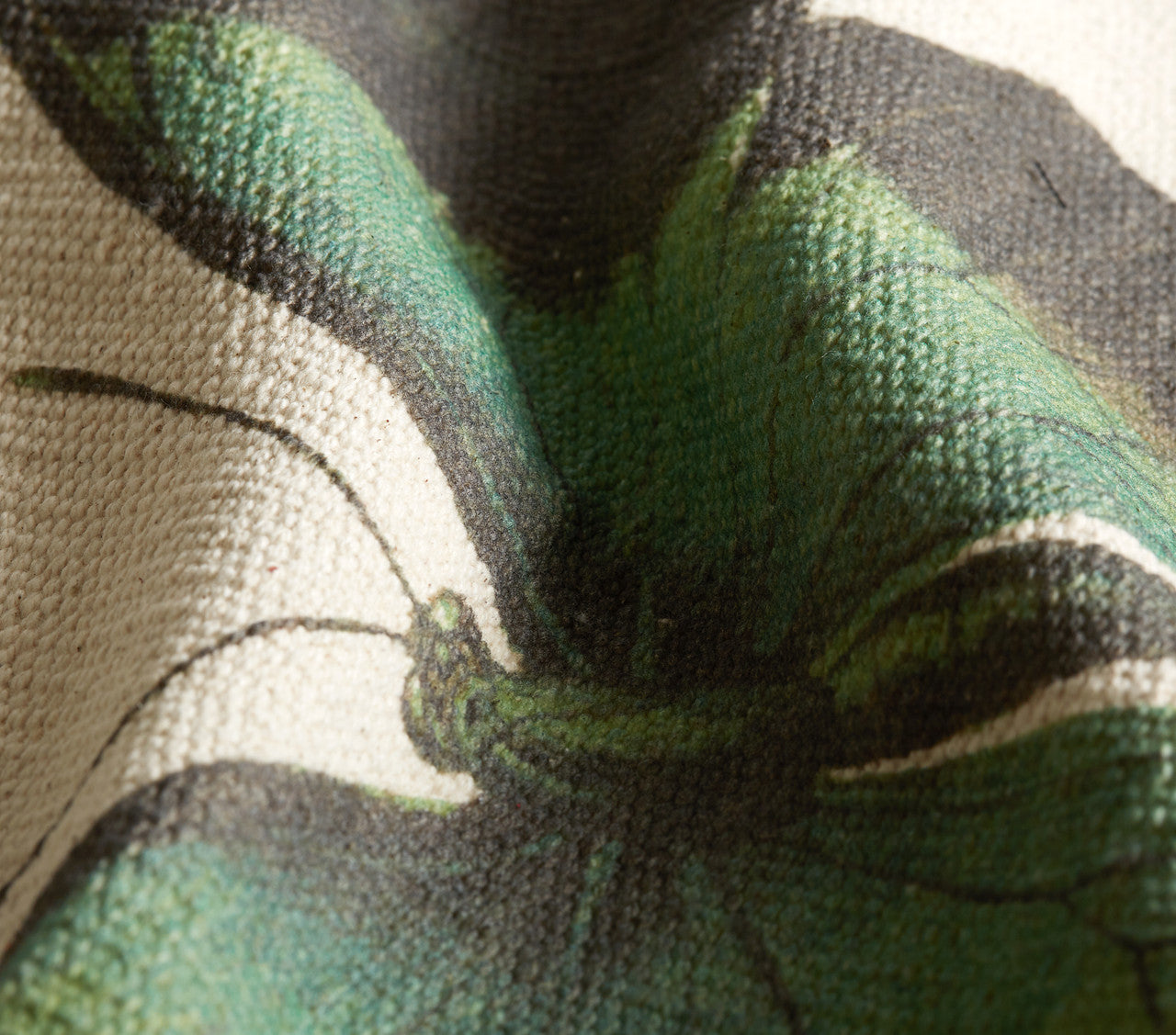 Close-up of a green butterfly on fabric with black and white patterns