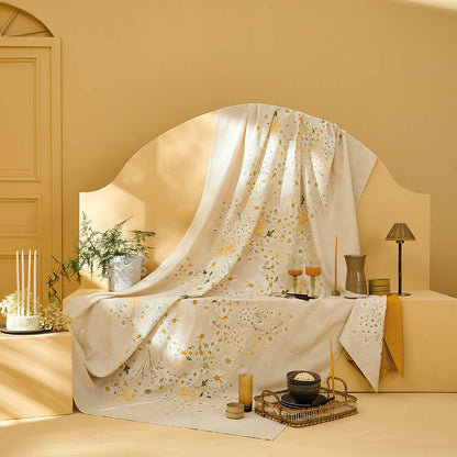 Daisy print chanvre cotton-linen tablecloth styled in a warm, neutral dining setting