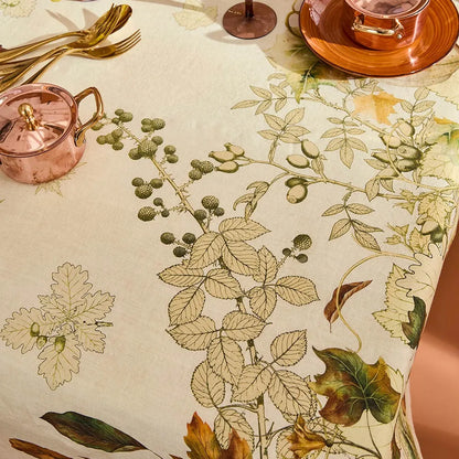 Close-up of cotton tablecloth with illustrated autumn leaf and vine pattern