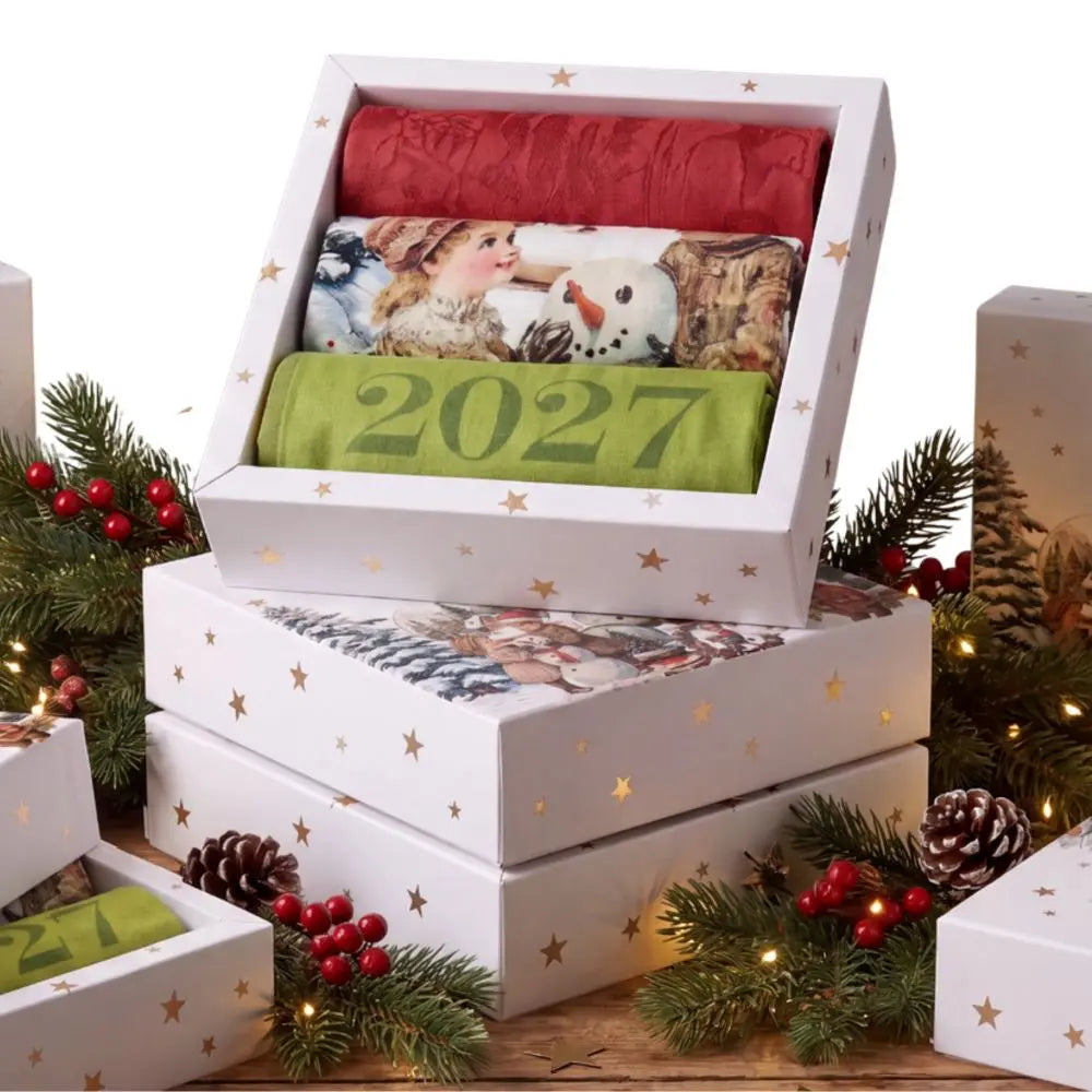 Holiday kitchen towel gift box set featuring three folded French dishtowels with a 2027 calendar design.