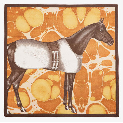 A square yellow Horse Marble cotton dinner napkin finished with a crisp, dark brown piped edge.