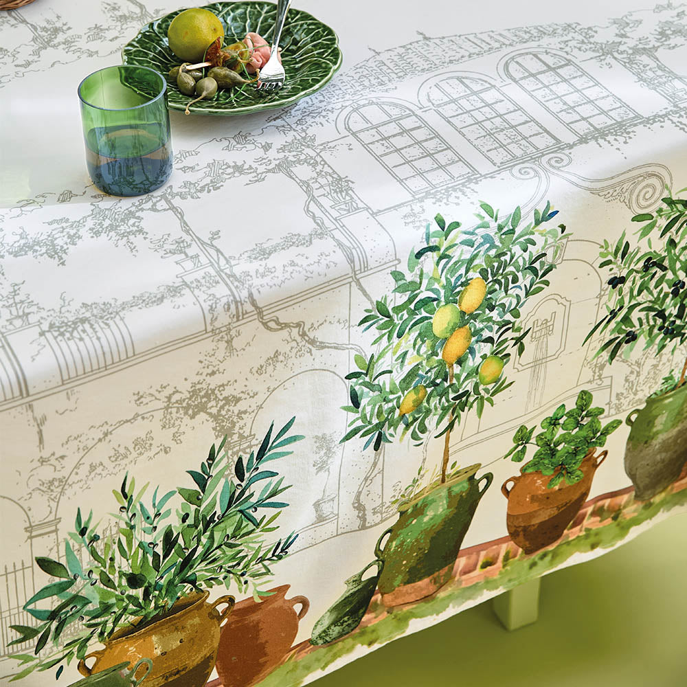 Close up of the Jardin Provencal Olive Tablecloth featuring hand sketches and potted plant paintings.