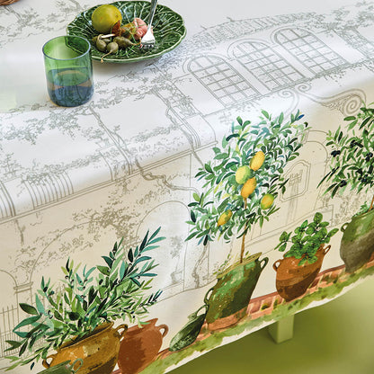 Close up of the Jardin Provencal Olive Tablecloth featuring hand sketches and potted plant paintings.