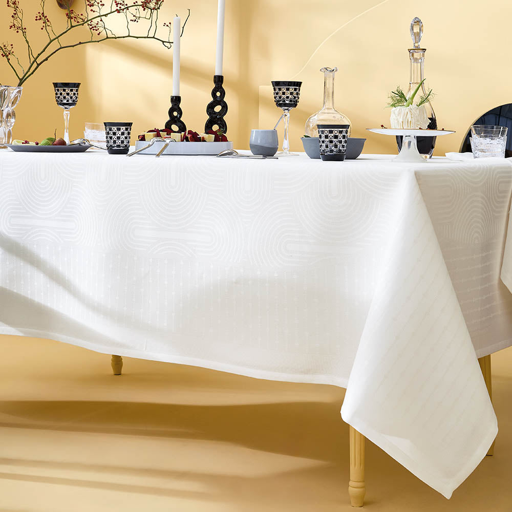 Close-up of Le Cercle Blanc jacquard woven cotton tablecloth featuring elegant table settings