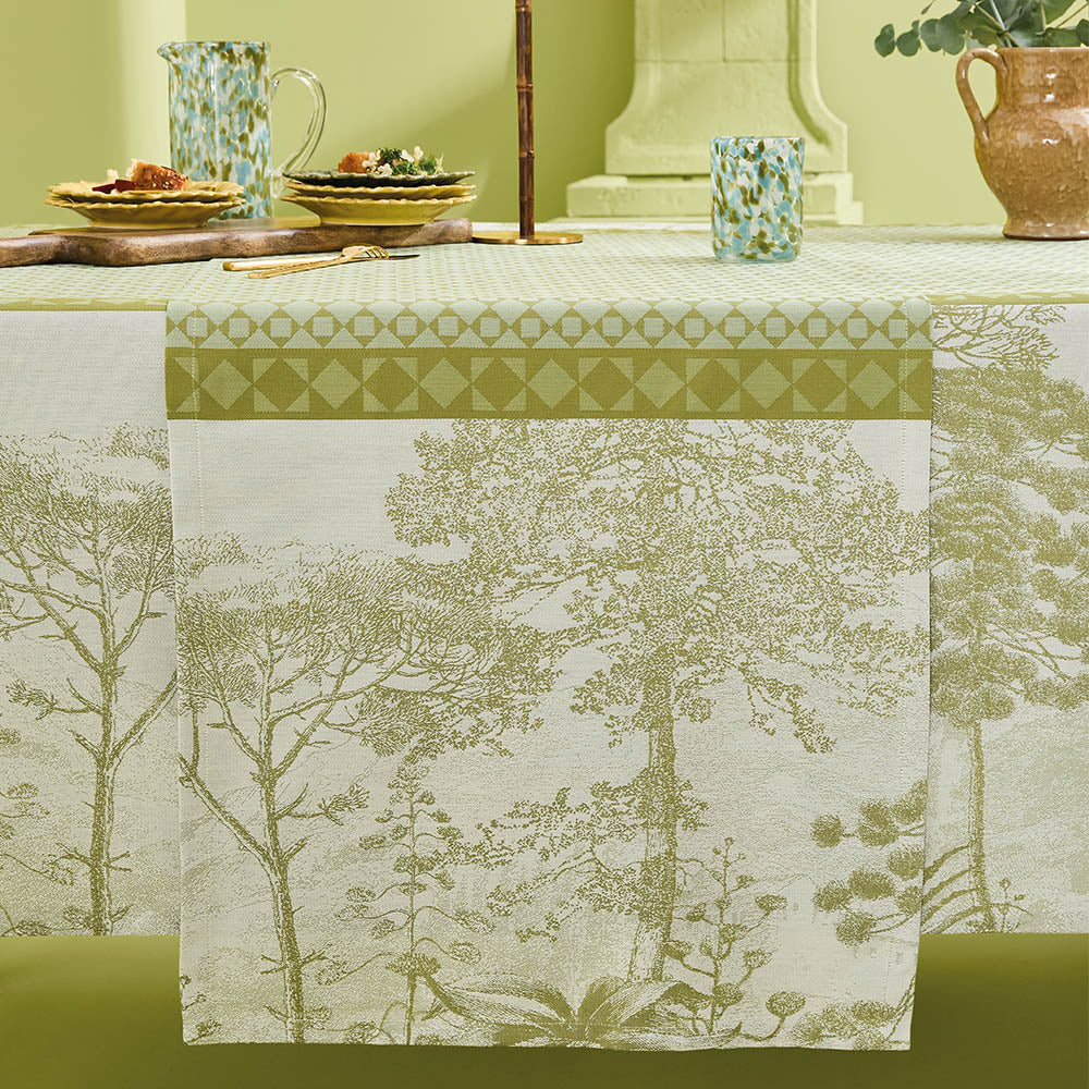 Le Sud Vert Jacquard Table Runner draping elegantly across a set table.