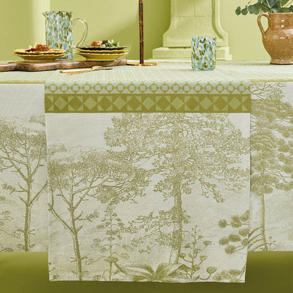Le Sud Vert Jacquard Table Runner draping elegantly across a set table.