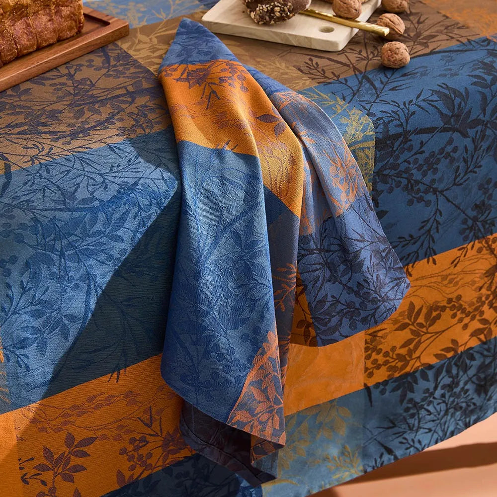 Blue and yellow cotton jacquard napkin with a leafy gingham plaid design from the Lavender Blue Mille Branchages Crepuscule collection.