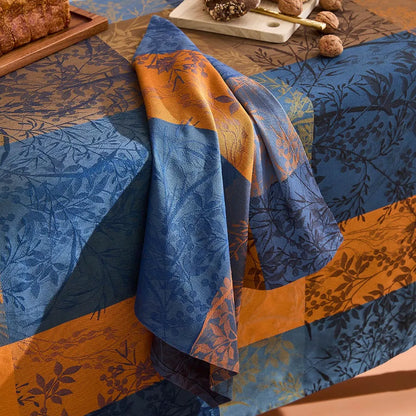 Blue and yellow cotton jacquard napkin with a leafy gingham plaid design from the Lavender Blue Mille Branchages Crepuscule collection.
