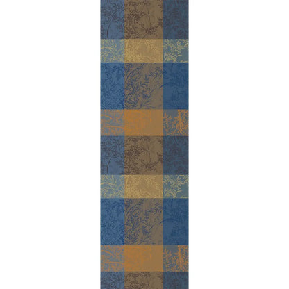 Mille Branchages table runner with a blue and gold checkered pattern on a white background