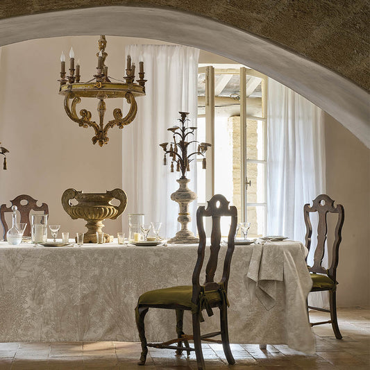 Mille Esprit Jardins Chanvre Coated Tablecloth, cream botanical floral cotton jacquard, set for dining in a rustic room.