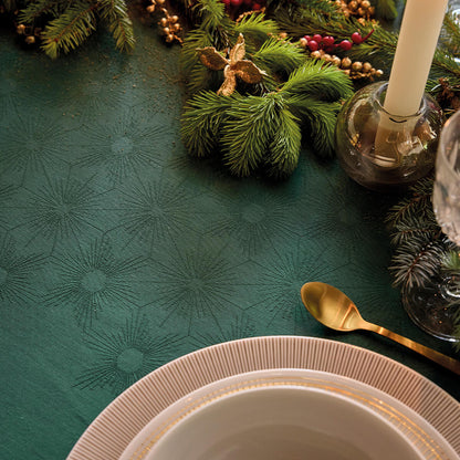 Close-up of the Sous Les Étoiles green cotton jacquard tablecloth showing starburst weave details.