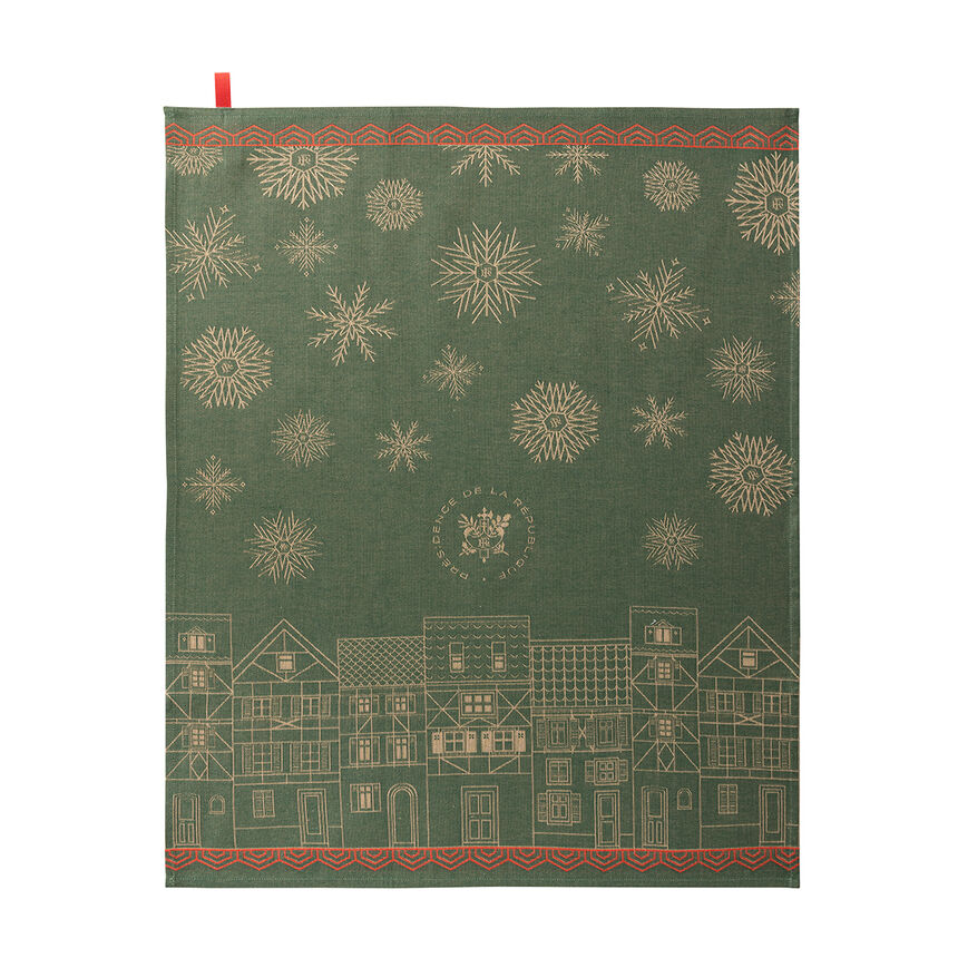 A forest green dishtowel featuring a festive Christmas design with gold snowflakes, a row of gold houses along the bottom, and red decorative borders at the top and bottom.