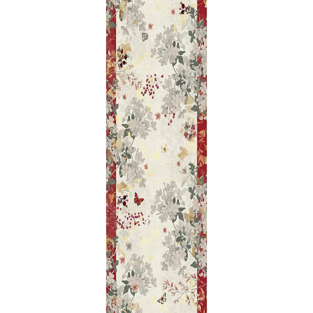 A vintage-themed table runner with a cream background, featuring a central floral and cranberry pattern in muted gray, sage green, and rust red, framed by red borders on the sides.