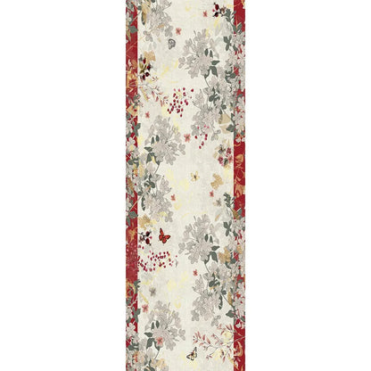 A vintage-themed table runner with a cream background, featuring a central floral and cranberry pattern in muted gray, sage green, and rust red, framed by red borders on the sides.