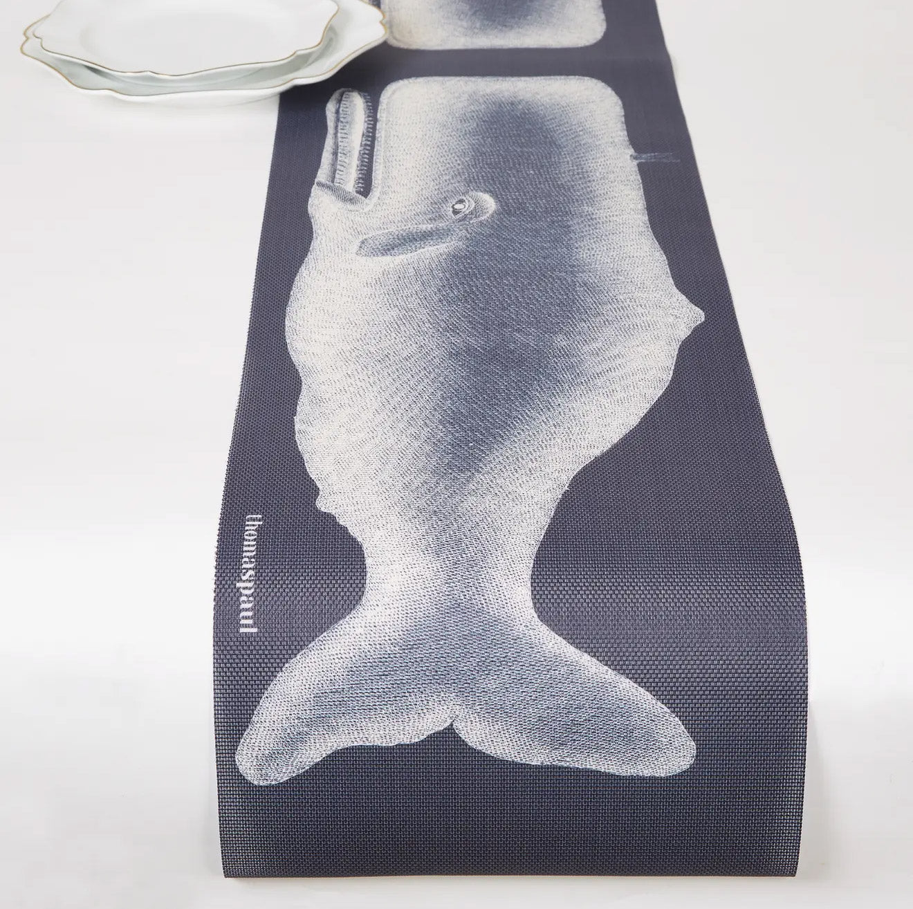Vinyl table runner with a whale illustration
